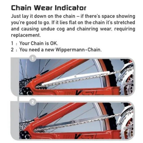 Bicycle chain wear indicator tool on bike chain showing when to replace a worn chain.