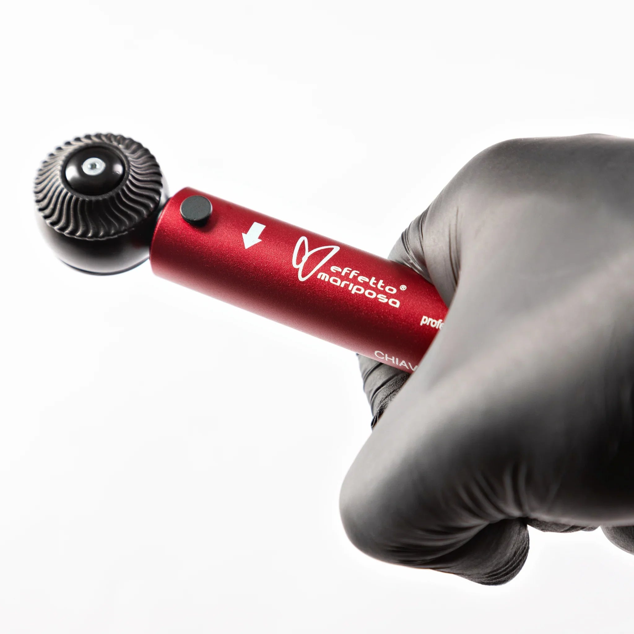 Red Effetto Mariposa Giustaforza torque wrench held in a gloved hand on white background