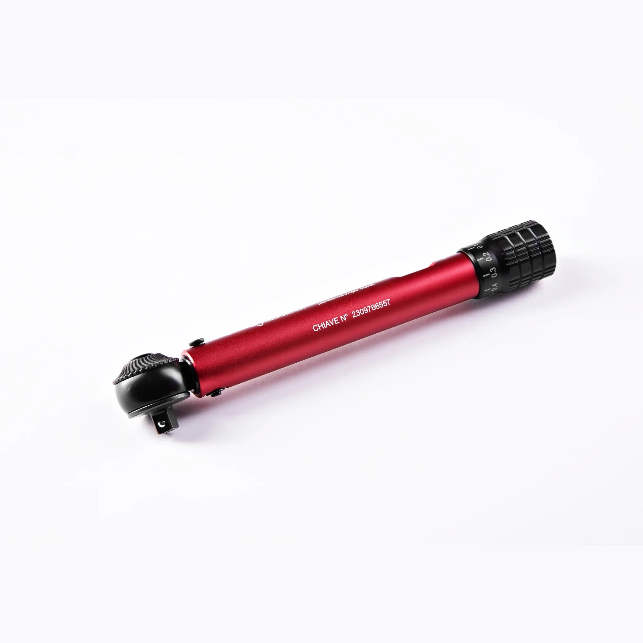 Red bicycle torque wrench with black grip and calibration dial on white background