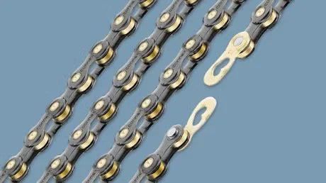 Bicycle chains with quick links on a blue background, close-up of chain details.