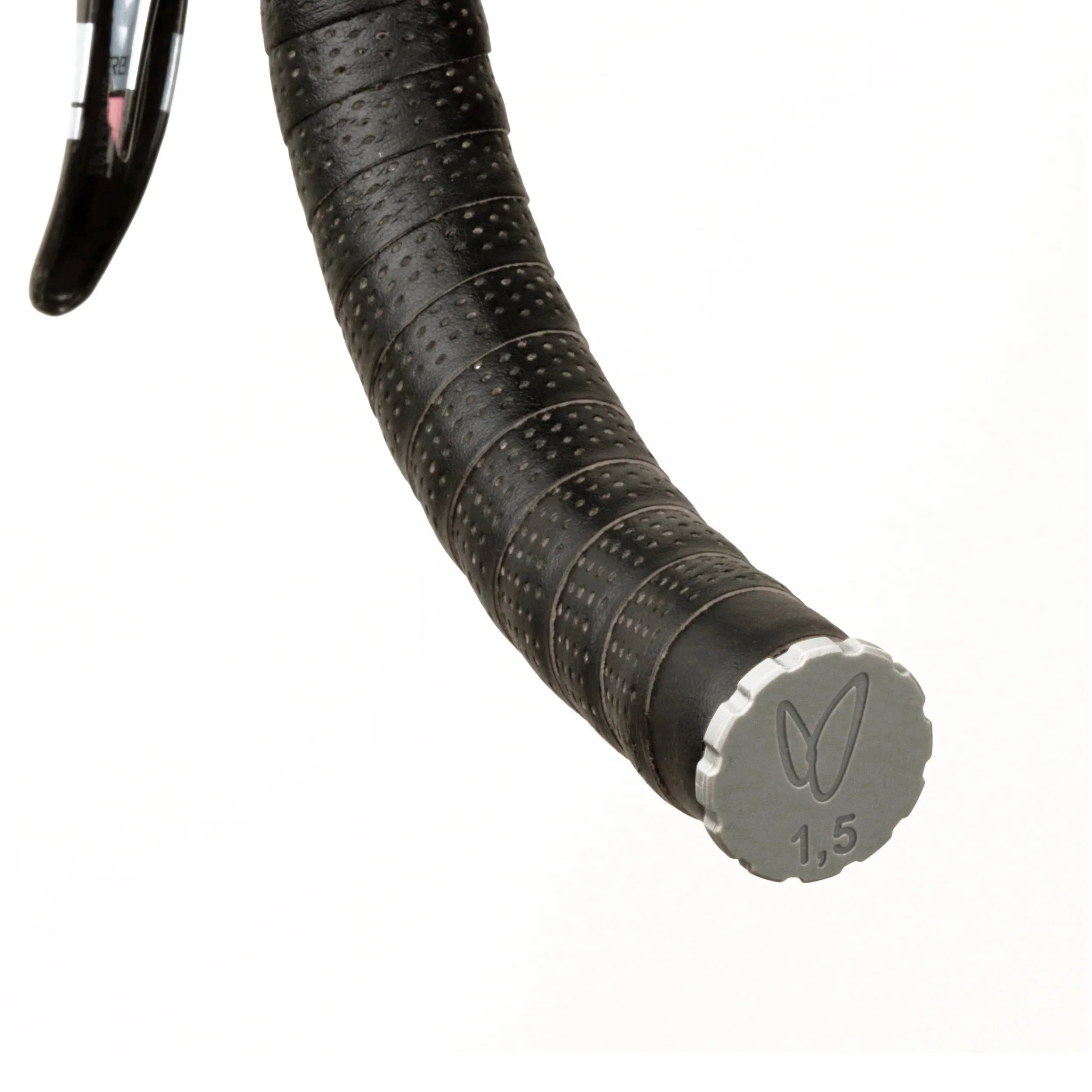 Close-up of black textured bicycle handlebar tape with tubeless tire plug tool as end cap,