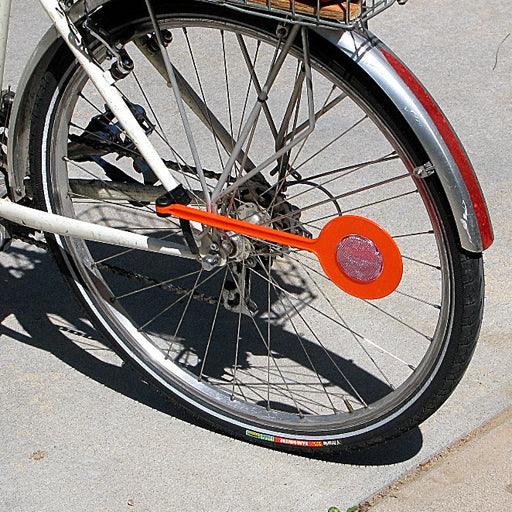 Bike rear wheel with attached orange safety wing reflector for increased visibility