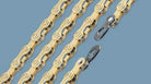 Gold bicycle chains with quick links on blue background, bike component detail