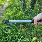 Hand holding a Giustaforza 1-60 Pro torque wrench with grass in the background